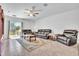 Comfortable living room with tile flooring, ceiling fan, and sliding glass doors to the patio at 659 Daring Dr, Davenport, FL 33837