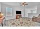 Bright living room featuring large windows, media center, plush rug, and a recliner chair at 659 Daring Dr, Davenport, FL 33837