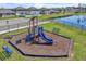 The playground has a play area with new playground equipment, a bench, and backs up to a pond at 659 Daring Dr, Davenport, FL 33837