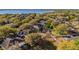 A panoramic aerial shot reveals a neighborhood nestled among mature trees with a lake visible in the background at 729 Strihal Loop, Oakland, FL 34787