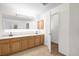 Bathroom featuring a double vanity and a commode visible through an open door at 729 Strihal Loop, Oakland, FL 34787