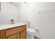 Well-lit half bathroom with a wood vanity, white countertops, and neutral wall color scheme at 729 Strihal Loop, Oakland, FL 34787