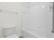 Full bathroom with white tiled shower, tub, and commode at 729 Strihal Loop, Oakland, FL 34787