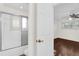 Bright bathroom with white shower-tub combo, and a peek into the light-filled bedroom with ceiling fan at 729 Strihal Loop, Oakland, FL 34787