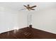 Bedroom with hardwood floors, ceiling fan, closet, and an open doorway at 729 Strihal Loop, Oakland, FL 34787