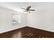 Cozy bedroom with hardwood floors, a ceiling fan, and shuttered windows for natural light at 729 Strihal Loop, Oakland, FL 34787