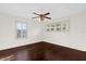 Bright bedroom featuring hardwood floors, a ceiling fan, and shuttered windows at 729 Strihal Loop, Oakland, FL 34787