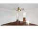 Inviting bedroom featuring hardwood floors, a ceiling fan, closet, and an ensuite bath at 729 Strihal Loop, Oakland, FL 34787