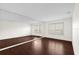 Spacious bonus room featuring dark hardwood flooring, white walls, and large mirrors along one wall at 729 Strihal Loop, Oakland, FL 34787