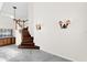 Inviting entryway features a wooden staircase, marble floors, and sconce lighting at 729 Strihal Loop, Oakland, FL 34787