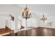 Bright entryway featuring wood floors, decorative light fixtures, and stairs at 729 Strihal Loop, Oakland, FL 34787