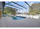 Beautiful enclosed pool area with cool deck and dark metal enclosure for safety at 729 Strihal Loop, Oakland, FL 34787