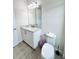 Well-lit powder room with a granite countertop, modern fixtures, and tile floors at 7717 Graben St, Kissimmee, FL 34747