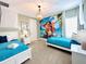 bedroom features two twin beds, nautical themed decor and a coastal themed mural on the accent wall at 7717 Graben St, Kissimmee, FL 34747