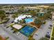 An aerial view of the community pool, clubhouse, basketball court, and surrounding neighborhood at 8136 Fan Palm Way, Kissimmee, FL 34747