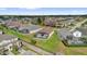 An aerial view of a backyard screened in pool, surrounded by other homes in a quiet neighborhood at 8136 Fan Palm Way, Kissimmee, FL 34747