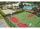 Aerial view of a basketball court with a pool and clubhouse in the background at 8136 Fan Palm Way, Kissimmee, FL 34747