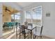 Bright dining area with sliding door access to the lanai and a view of the pool area at 8136 Fan Palm Way, Kissimmee, FL 34747