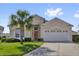 Charming single-Gathering home featuring a well-manicured lawn and a mature palm tree at 8136 Fan Palm Way, Kissimmee, FL 34747