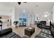 Cozy living room with tile flooring, a ceiling fan, and comfortable leather furniture at 8136 Fan Palm Way, Kissimmee, FL 34747