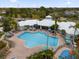 Community clubhouse and pool featuring ample lounge seating and shady umbrellas at 8136 Fan Palm Way, Kissimmee, FL 34747