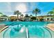 A luxurious community pool surrounded by palm trees, offering a relaxing resort-style experience at 8136 Fan Palm Way, Kissimmee, FL 34747