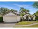 Charming single-Gathering home featuring a two-car garage, arched entryway and fresh landscaping at 8534 Black Mesa Dr, Orlando, FL 32829