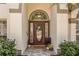 Close up of the front door with decorative glass and a welcome mat on a brick paver path at 8534 Black Mesa Dr, Orlando, FL 32829