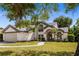 Charming two-story home featuring an attached garage and beautiful landscaping at 8534 Black Mesa Dr, Orlando, FL 32829