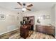 Functional home office with wood-look floors, a large desk, and stylish furnishings at 8534 Black Mesa Dr, Orlando, FL 32829