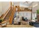 Spacious living room featuring staircase leading to the second level, wood floors and high ceilings at 8534 Black Mesa Dr, Orlando, FL 32829