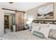 Comfortable primary bedroom with barn door leading to the ensuite bathroom at 8534 Black Mesa Dr, Orlando, FL 32829