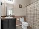 Well-maintained bathroom with a dark vanity and a shower featuring a striped curtain at 8813 Tatara, Orlando, FL 32836