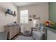 Bright Bedroom showcasing a changing table, comfortable armchair, and soft grey rug at 8813 Tatara, Orlando, FL 32836