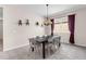 Dining room with modern light fixture, decorative wall shelves, large window and seating for eight at 8813 Tatara, Orlando, FL 32836