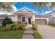 Charming single-story home featuring a well-manicured lawn, brick walkway, and an attached two-car garage at 8813 Tatara, Orlando, FL 32836