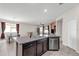 Kitchen island with stainless steel dishwasher and sink overlooking the dining area and living room at 8813 Tatara, Orlando, FL 32836