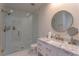 Sleek bathroom with glass shower, marble vanity, and gold fixtures at 8929 Charleston Park # 12, Orlando, FL 32819