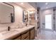 Bright bathroom featuring a double vanity with marble counters and a shower with marble surround at 8929 Charleston Park # 12, Orlando, FL 32819