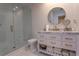 Modern bathroom with marble-top vanity, glass shower, and sleek gold fixtures at 8929 Charleston Park # 12, Orlando, FL 32819