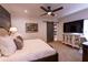 Bedroom featuring wood floors, barn door access to bathroom, and a modern console with tv at 8929 Charleston Park # 12, Orlando, FL 32819