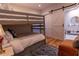 Bunk bedroom featuring a barn door to the bathroom with marble vanity at 8929 Charleston Park # 12, Orlando, FL 32819