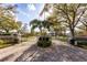 Inviting entrance to Bay Hill Village, featuring lush landscaping and a secure gated entry at 8929 Charleston Park # 12, Orlando, FL 32819