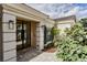 Stylish front entrance with a modern black framed door, beautiful brick walkway, and manicured landscaping at 8929 Charleston Park # 12, Orlando, FL 32819