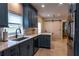 Bright kitchen with blue cabinets, modern countertops, and seamless access to a pantry through a sliding barn door at 8929 Charleston Park # 12, Orlando, FL 32819