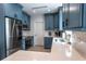 Well-equipped kitchen with blue cabinetry, stainless steel appliances, quartz countertops, and modern fixtures at 8929 Charleston Park # 12, Orlando, FL 32819