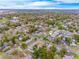 An aerial view showing the neighborhood and surrounding trees at 936 N Baker St, Mount Dora, FL 32757