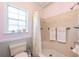 Traditional bathroom with a tile shower and peach and gray color scheme at 936 N Baker St, Mount Dora, FL 32757