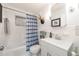 Clean bathroom featuring a tub with shower, vanity with modern faucet, and blue and white shower curtain at 936 N Baker St, Mount Dora, FL 32757