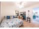 Comfortable bedroom featuring a floral bedspread, a reading chair, and built-in cabinets at 936 N Baker St, Mount Dora, FL 32757